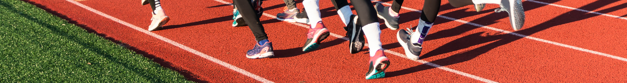 Photograph of a racetrack and running feet 